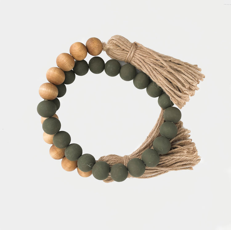 GREEN AND WALNUT WOODEN BEADS WITH JUTE TASSELS